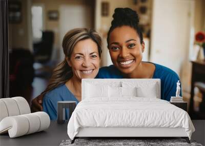 Two women in blue scrubs are smiling at the camera Wall mural