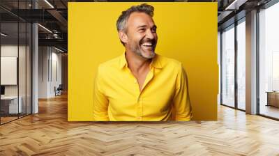 Ultra handsome Caucasian, smiling and laughing, wearing bright clothes. Bright solid yellow background. created by generative AI technology. Wall mural