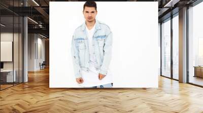 Portrait of handsome young model man dressed in jeans clothes posing on white background. Isolated Wall mural