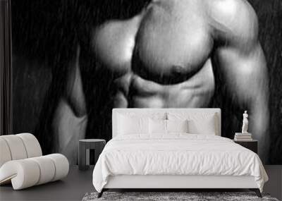 Portrait of strong healthy handsome Athletic Man Fitness Model posing near dark gray wall in the rain Wall mural