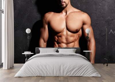 Portrait of strong healthy handsome Athletic Man Fitness Model posing near dark gray wall Wall mural