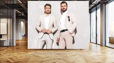 portrait of two handsome confident stylish hipster lambersexual models. sexy modern men dressed in w Wall mural