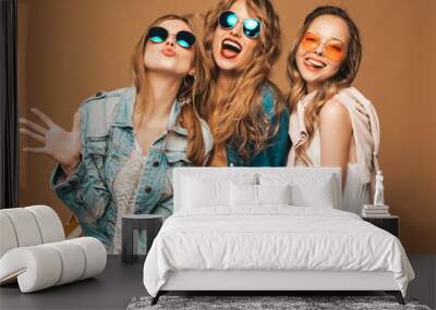 three beautiful smiling hipster girls in trendy summer casual clothes and sunglasses. sexy carefree  Wall mural