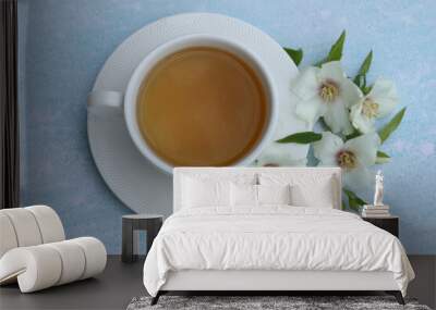 cup of herbal tea with jasmine flowers on blue background  Wall mural