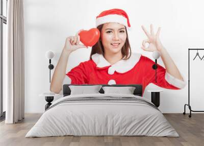 Asian Christmas girl show OK with Santa Claus clothes with red h Wall mural