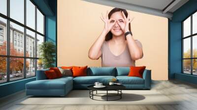 Asian woman do funny  double OK sign as glasses. Wall mural