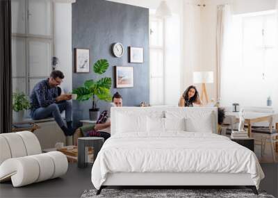 A group of young friends relaxing indoors, house sharing concept. Wall mural