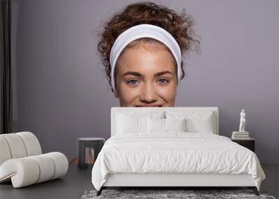 A portrait of a young woman in a studio, beauty and skin care. Wall mural