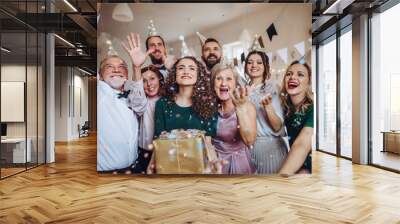 A portrait of multigeneration family with presents on a indoor birthday party. Wall mural