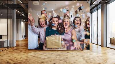 A portrait of multigeneration family with presents on a indoor birthday party. Wall mural