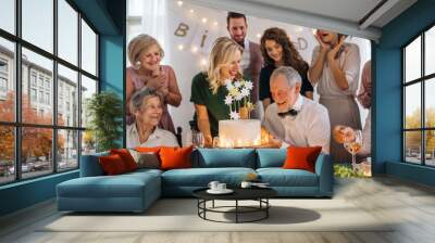 A senior man with multigeneration family celebrating birthday on indoor party. Wall mural