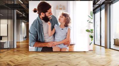 A small girl with young father at home, talking. Copy space. Wall mural