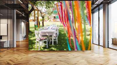 A table set for kids birthday party outdoors in garden in summer. Wall mural