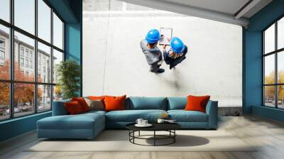 A top view of an industrial man and woman engineer with clipboard in a factory. Wall mural