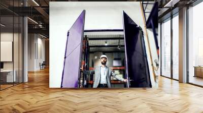 An industrial man engineer in a factory, opening the gate. Wall mural