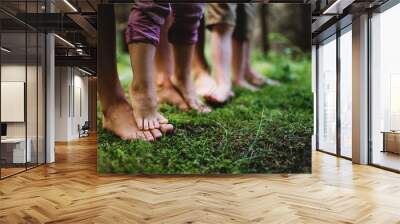 Bare feet of family with small children standing barefoot outdoors in nature, grounding concept. Wall mural