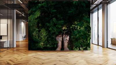 Bare feet of woman standing barefoot outdoors in nature, grounding concept. Wall mural