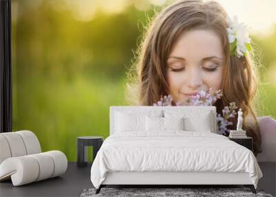 Beautiful spring girl with flowers on the meadow Wall mural