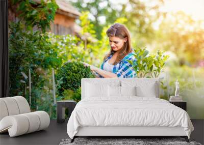 Beautiful young woman gardening Wall mural