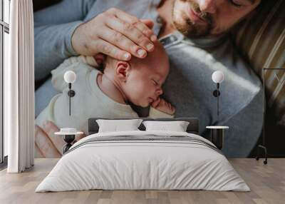 Close-up of father cudddling his little son. Wall mural