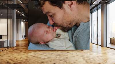 Close-up of father cudddling his little son. Wall mural