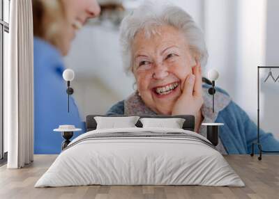 Close up of nurse stroking cheek of senior woman. Wall mural