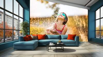 Cute little girl having fun outside Wall mural