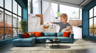 Cute small toddler girl indoors in bedroom playing. Wall mural