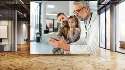 Doctor explaining results of MRI scan of brain to father of young girl patient. Diagnosis of diseases and head injuries. Wall mural