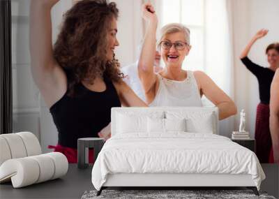 Group of senior people in dancing class with dance teacher. Wall mural