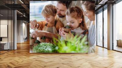 Happy family planting herbs together at spring. Wall mural