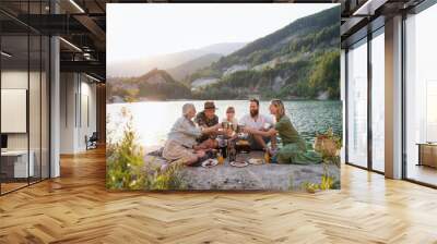 Happy multigeneration family on summer holiday trip, barbecue by lake. Wall mural