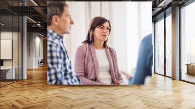 Men and women sitting in a circle during group therapy, talking. Wall mural