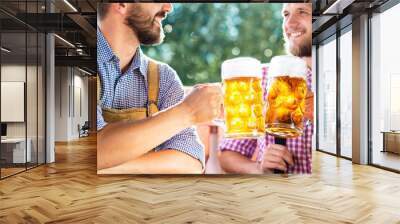 Men in traditional bavarian clothes holding mugs of beer Wall mural