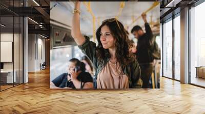 Mid adult woman commuter is standing in bus and travelling in public transport. Wall mural