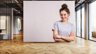 Portrait of a young beautiful woman in studio. Wall mural