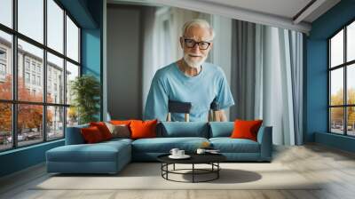 Portrait of an elderly man with crutches. Wall mural