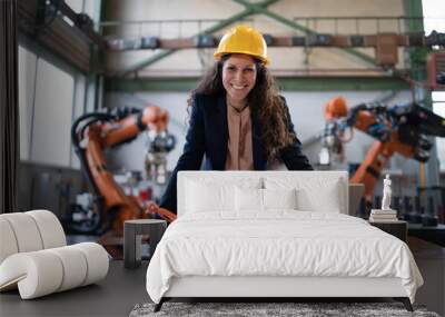 Portrait of female chief engineer in modern industrial factory using computer. Wall mural