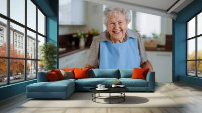 Portrait of senior woman with fresh baked bread. Wall mural