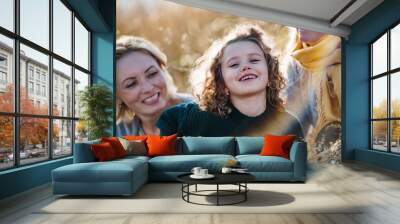 Portrait of small girl with mother and grandmother resting in autumn nature. Wall mural