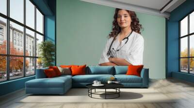 Portrait of young curly nurse, studio shoot. Wall mural