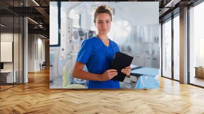 Portrait of young nurse in surgical department. Wall mural