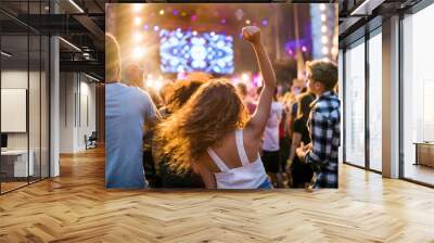 Rear view of group of young friends dancing at summer festival. Wall mural