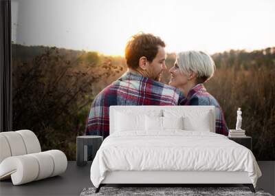 Rear view of young couple in love on a walk in autumn nature. Wall mural