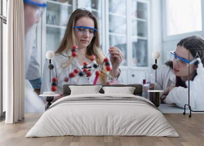 Science students doing chemical experiment in the laboratory at university. Wall mural