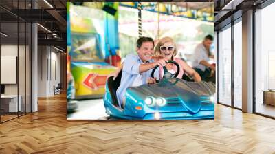 senior couple in the bumper car at the fun fair Wall mural