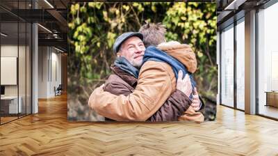 Senior father and his young son on a walk. Wall mural