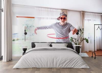 Senior man having fun at home. Wall mural