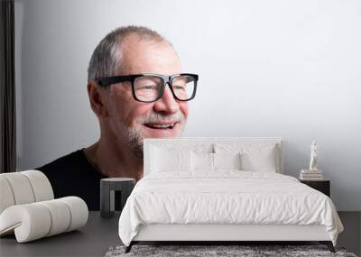 senior man in black t-shirt and eyeglasses, studio shot. Wall mural