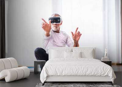 Senior man with VR goggles doing exercise at home. Wall mural